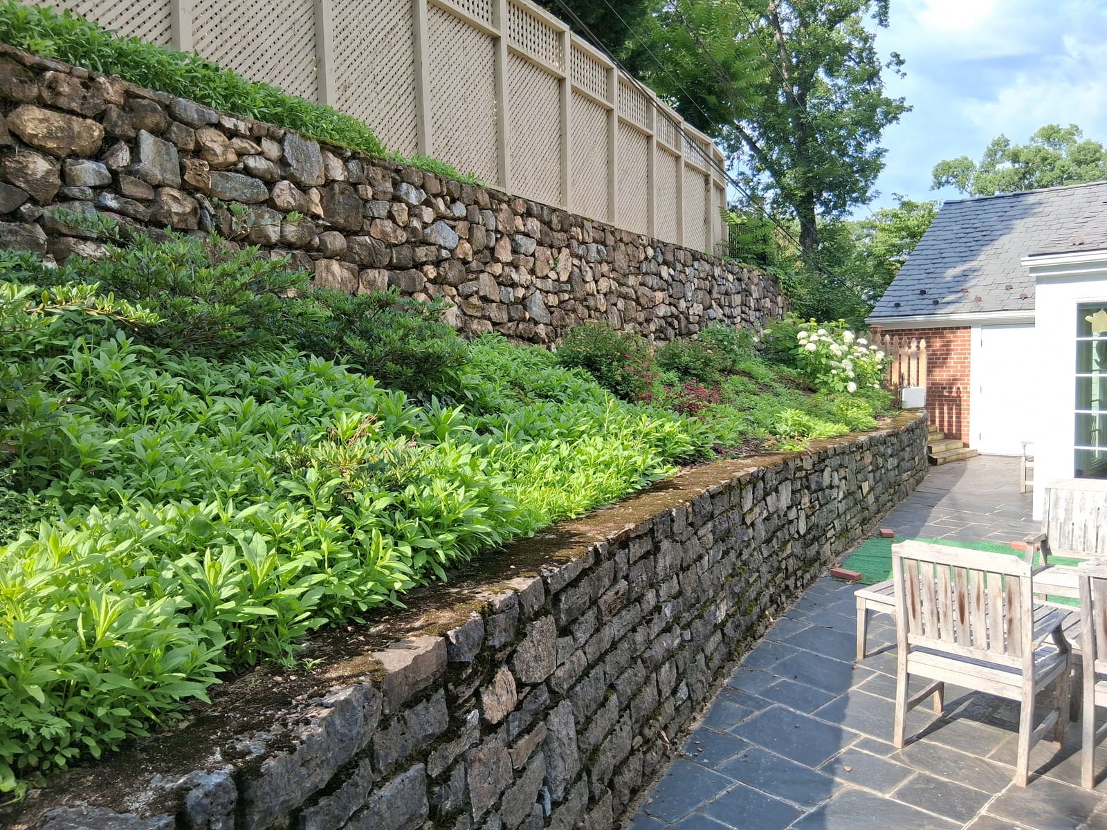 Stone wall planting bed before service